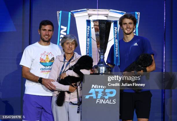 Alexander Zverev of Germany, Mischa Zverev, Brother and Coach along with his mother and dogs pose with the trophy after the Men's Single's Final...