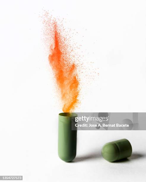 open medicine capsule pill with an explosion of healing molecules on a white background. - prescription drugs dangers stock pictures, royalty-free photos & images