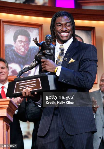 Robert Griffin III of the Baylor Bears poses with the trophy after being named the 77th Heisman Memorial Trophy Award winner at the Best Buy Theater...