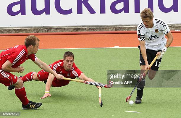 Mark Pearn and Mark Glenghorne of Britain competes with Benjamin Wess of Germany during their playoff for 5th and 6th on the finals day of the men's...