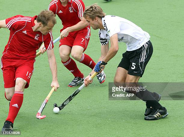 Mark Pearn and Ashley Jackson of Britain competes with Florian Wosech of Germany during their playoff for 5th and 6th on the finals day of the men's...