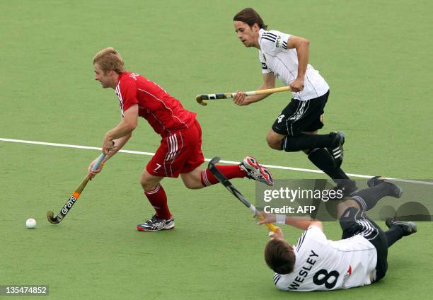 Ashley Jackson of Britain competes with Benedikt Furk and Christopher Wesley of Germany during their playoff for 5th and 6th on the finals day of the...