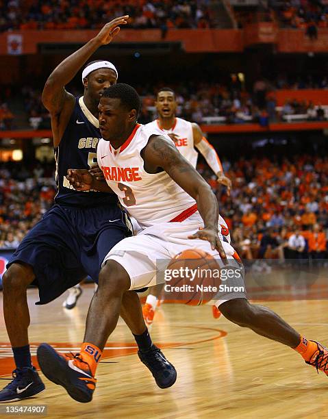 Dion Waiters of the Syracuse Orange drives to the basket against Bryan Bynes of the George Washington Colonials during the game at the Carrier Dome...