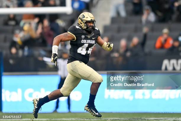 Linebacker Devin Grant of the Colorado Buffaloes runs off the field to celebrate a defensive stop against the Washington Huskies during a game at...