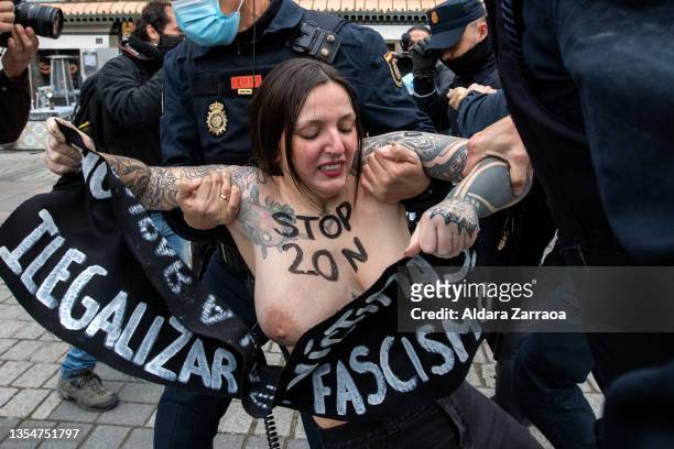 Femen activist is arrested by the police during the commemoration of the 46th anniversary of dictator Franco's death on November 21, 2021 in Madrid,...