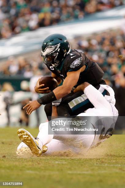 Cameron Jordan of the New Orleans Saints tackles Jalen Hurts of the Philadelphia Eagles during the fourth quarter at Lincoln Financial Field on...
