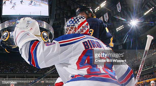 Martin Biron of the New York Rangers looks back after making a glove save against the Buffalo Sabres at First Niagara Center on December 10, 2011 in...