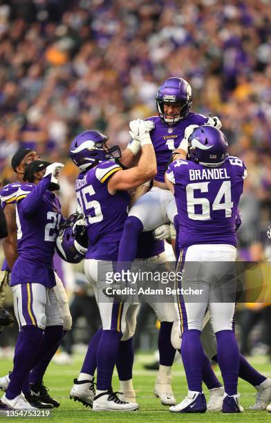 Greg Joseph of the Minnesota Vikings celebrates with teammates after a game winning field goal against the Green Bay Packers in the fourth quarter at...