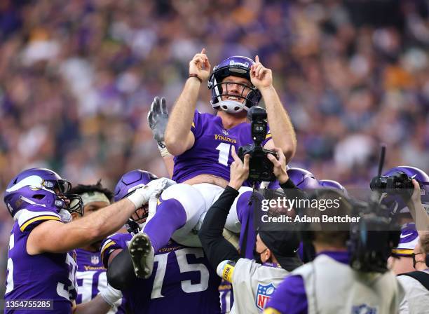 Greg Joseph of the Minnesota Vikings celebrates with teammates after a game winning field goal against the Green Bay Packers in the fourth quarter at...