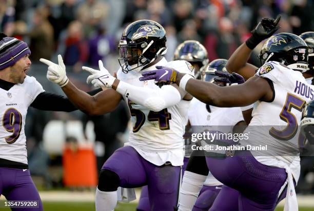 Tyus Bowser and Justin Houston of the Baltimore Ravens react after a play in the game against the Chicago Bears during the fourth quarter at Soldier...