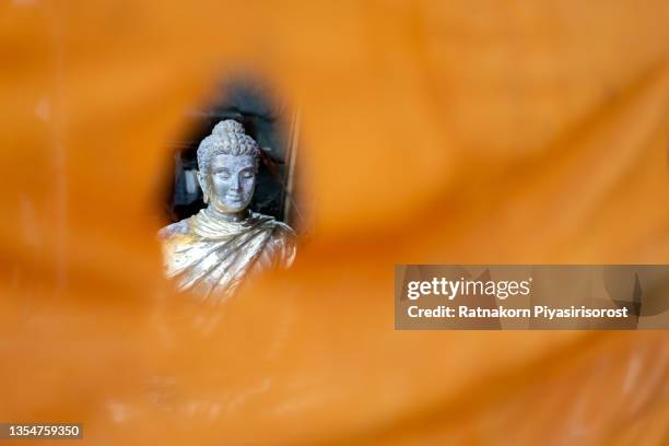 yellow fabric cloth with buddha statue face - flower close up stock pictures, royalty-free photos & images