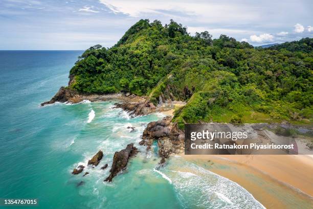 aerial view of a beautiful, empty tropical beach surrounded by lush green foliage at na yak mountain, tai meung beach, phang nga province, thailand - khao lak stock pictures, royalty-free photos & images