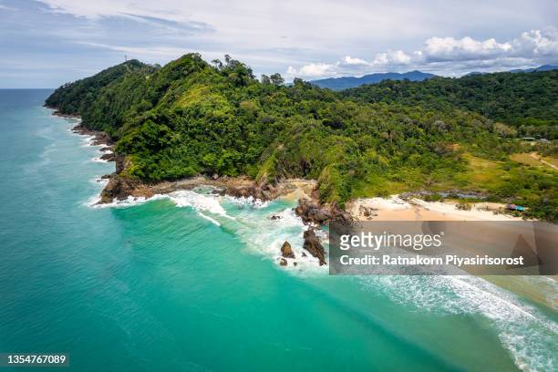 aerial view of a beautiful, empty tropical beach surrounded by lush green foliage at na yak mountain, tai meung beach, phang nga province, thailand - khao lak stock pictures, royalty-free photos & images