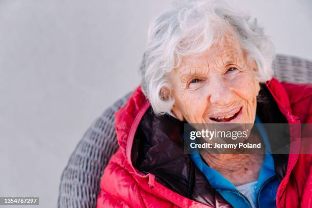 close-up shot of a beautiful, cheerful smiling 100-year-old elderly senior caucasian woman sitting outdoors - up 103 86 stock pictures, royalty-free photos & images