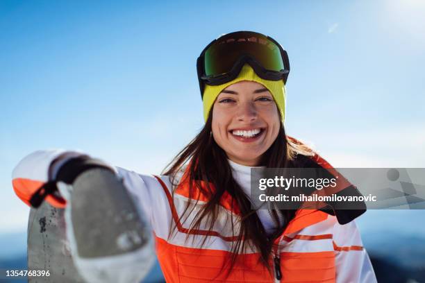 skiing has always been one of her favourite pastimes - woman snowboarding stock pictures, royalty-free photos & images