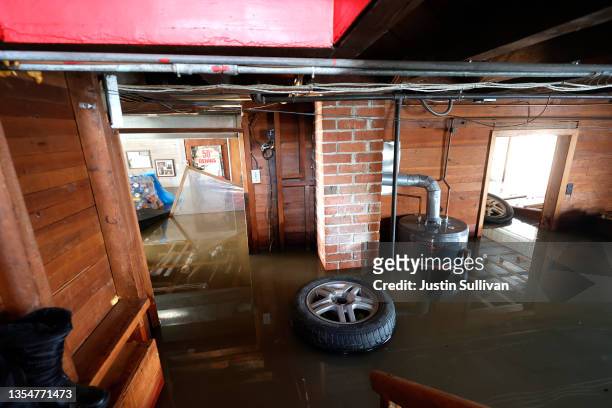 Wheel floats in the basement of Dennis and Wendy Penner's flooded home on November 21, 2021 in Abbotsford, British Columbia. Residents and farmers...