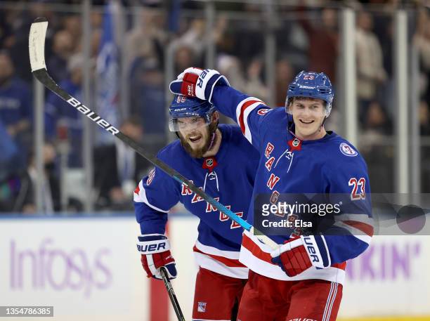 Ryan Lindgren of the New York Rangers is congratulated by teammate Adam Fox after Lindgren scored the game winning goal in the final seconds of the...