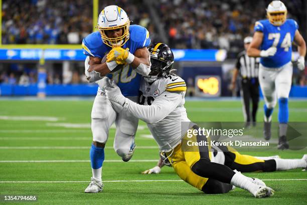 Austin Ekeler of the Los Angeles Chargers carries the ball as Taco Charlton of the Pittsburgh Steelers defends in the third quarter at SoFi Stadium...
