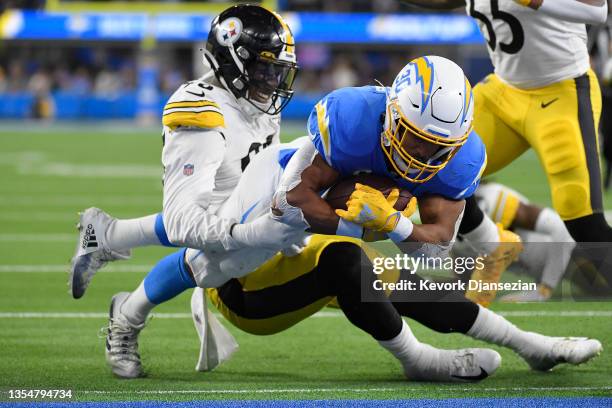 Austin Ekeler of the Los Angeles Chargers dives for a touchdown as Taco Charlton of the Pittsburgh Steelers defends in the third quarter at SoFi...