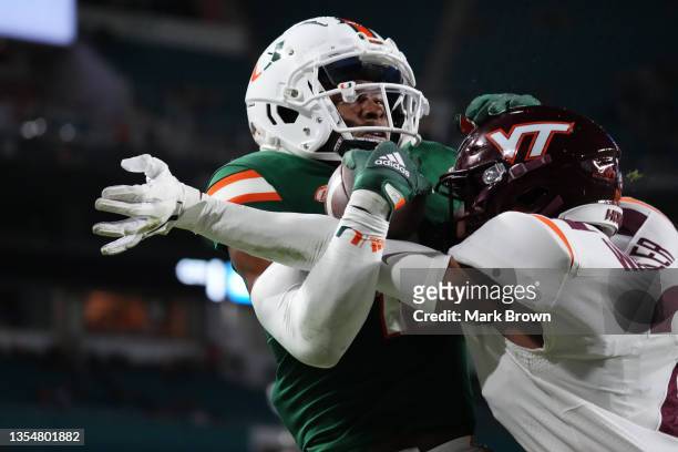 Charleston Rambo of the Miami Hurricanes makes a catch for a touchdown against the Virginia Tech Hokies at Hard Rock Stadium on November 20, 2021 in...