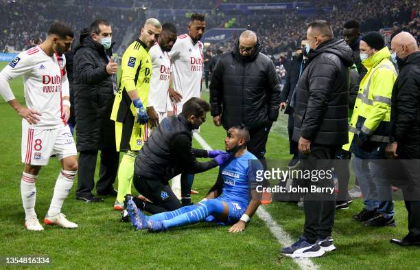 The match is stopped after only few minutes when Dimitri Payet of OM - here checked by the doctor - is hit by a plastic bottle of water thrown by a...