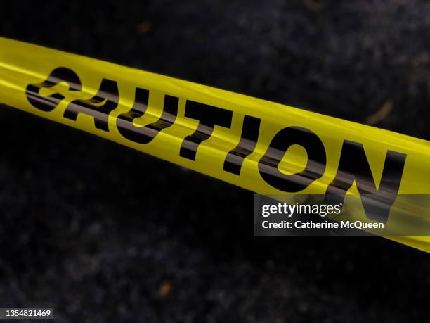 standard yellow caution tape - crime scene stock pictures, royalty-free photos & images