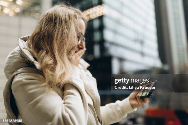 woman looking at the phone graphs of the spread of coronavirus. - infectious disease contact diagram stock pictures, royalty-free photos & images