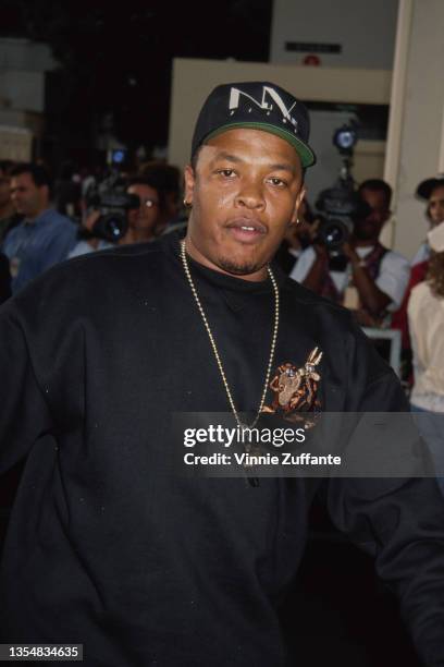 American rapper and record producer Dr Dre, wearing a 'Nu Vue Films' baseball cap, a gold chain which hangs a whistle, and a black sweatshirt which...