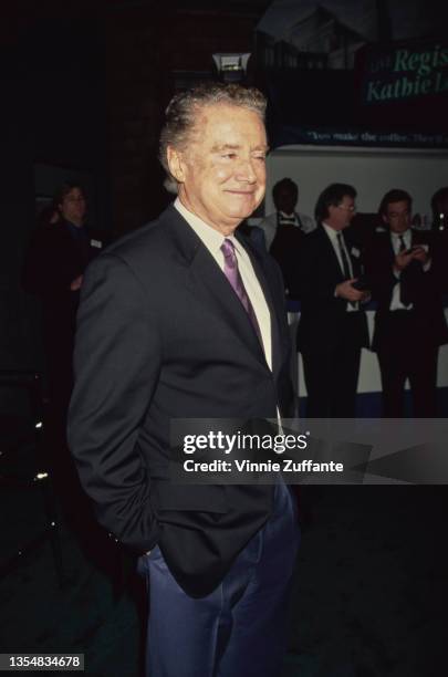 American television presenter Regis Philbin , wearing a black blazer with his hands in his trouser pockets, attends the 36th Annual National...