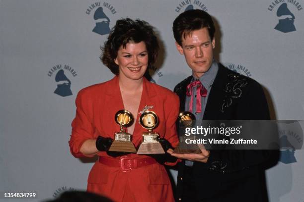 American country music singer�songwriter KT Oslin and American country music singer�songwriter Randy Travis, wearing a pink western bow tie, a grey...