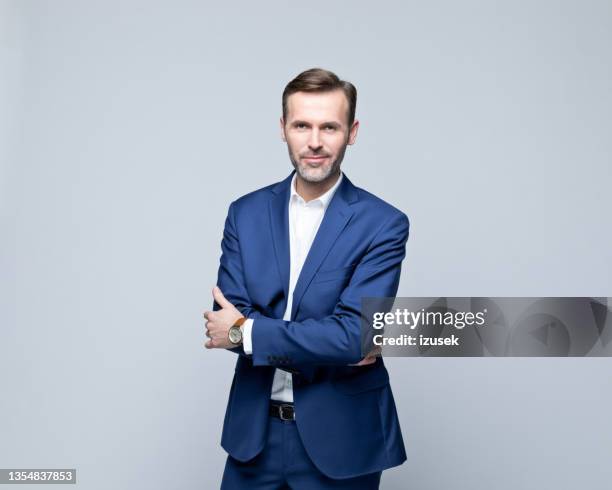 portrait of confident mature businessman - grey background stock pictures, royalty-free photos & images