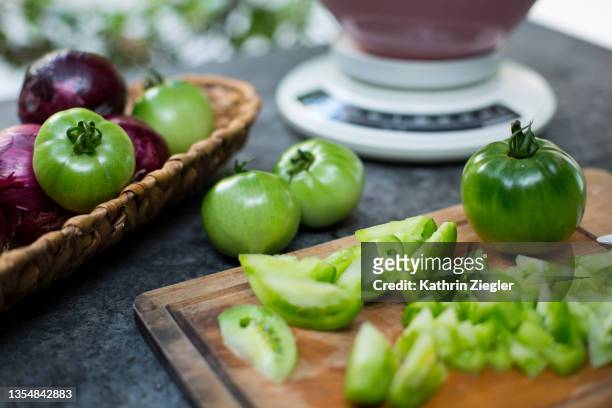 sliced green tomatoes on cutting board - kitchen scale stock pictures, royalty-free photos & images