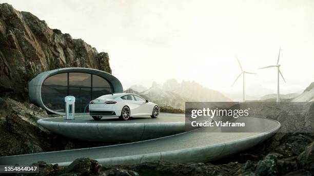 electric car charging with wind turbines - futuristisch stockfoto's en -beelden