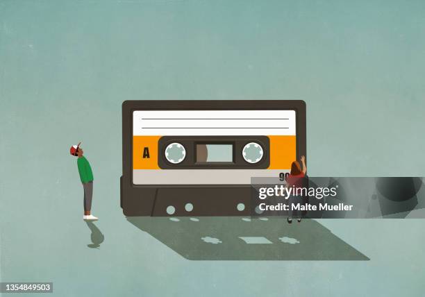 bildbanksillustrationer, clip art samt tecknat material och ikoner med boy and girl looking at cassette tape - audio cassette