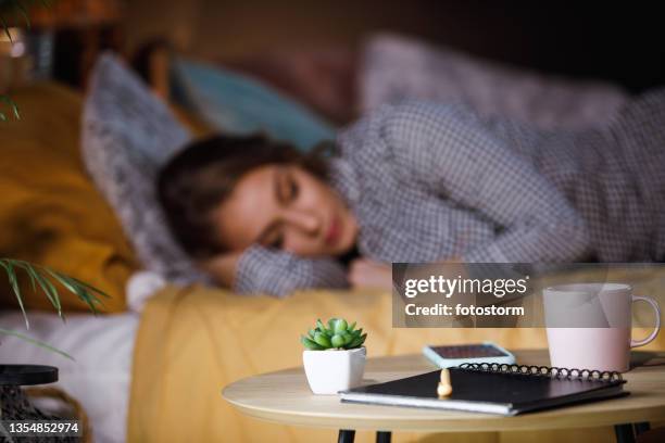 teenage girl sleeping in her cozy bed - bedside table stock pictures, royalty-free photos & images