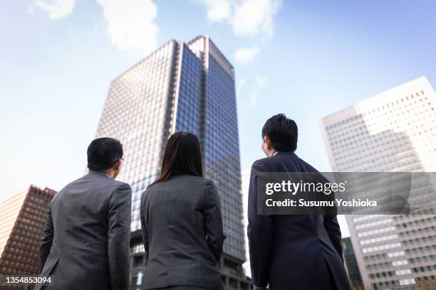 businessmen meeting and working in a big city. - bussines group suit tie stock-fotos und bilder