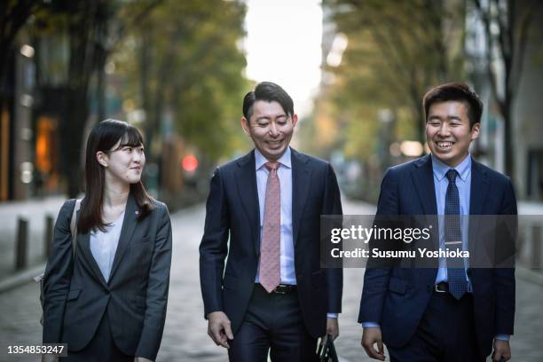 businessmen meeting and working in a big city. - bussines group suit tie fotografías e imágenes de stock