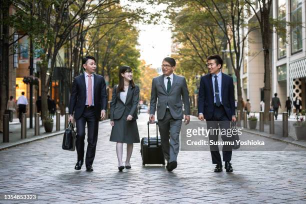 businessmen meeting and working in a big city. - bussines group suit tie fotografías e imágenes de stock