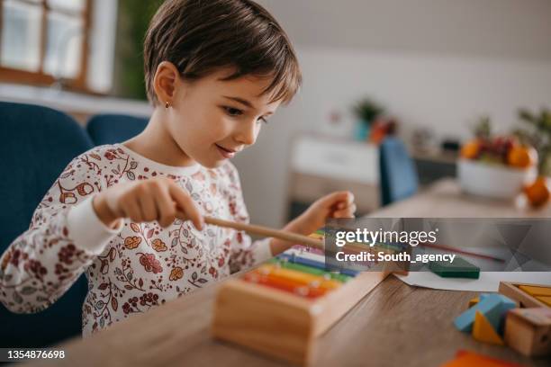 little girl playing xylophone - xylophone stock pictures, royalty-free photos & images