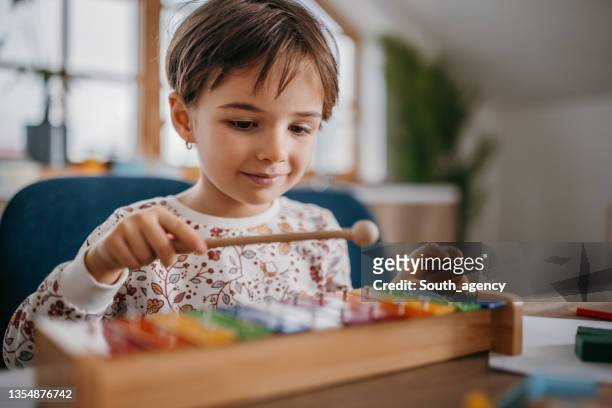 little girl playing xylophone - xylophone stock pictures, royalty-free photos & images