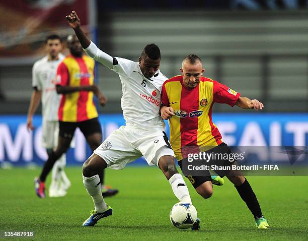 Wajdi Bouazzi of Esperance Sportive De Tunis is challenged by Kasola Mohammed of Al-Sadd Sports Club during the FIFA Club World Cup Quarter Final...