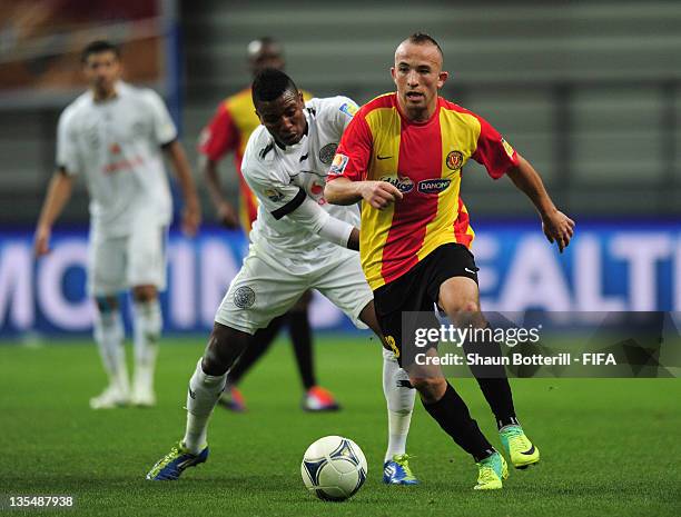 Wajdi Bouazzi of Esperance Sportive De Tunis is challenged by Kasola Mohammed of Al-Sadd Sports Club during the FIFA Club World Cup Quarter Final...