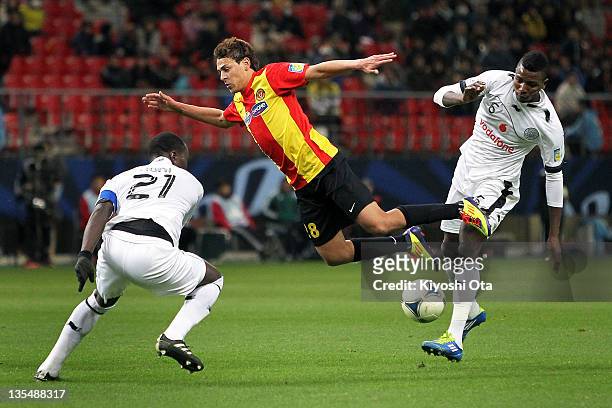 Youssef Msakni of Esperance Sportive de Tunis is challenged by Mohammed Kasola of Al-Sadd during the FIFA Club World Cup Quarter Final match between...