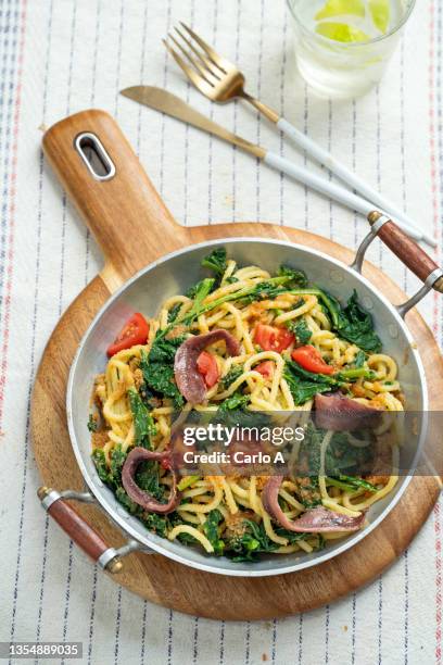 pasta with broccoli rabe  tomatoes and anchovies - breadcrumb stock pictures, royalty-free photos & images