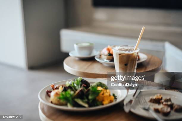 delicious and healthy brunch with all day breakfast, avocado toast with salmon and coffee freshly served on the table in a cafe. a balanced and healthy meal to start a great day ahead. food and lifestyle - breakfast no people stock pictures, royalty-free photos & images