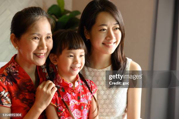 three generations asian chinese family celebrating chinese new year together - 30 year old portrait in house stockfoto's en -beelden