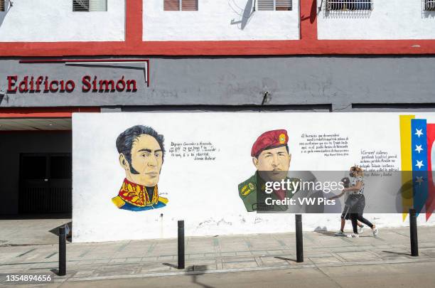 Mural of Simon Bolivar and Hugo Chavez at the entrance of a building called Simon in Caracas. Venezuelans vote on Sunday, November 21, in state and...