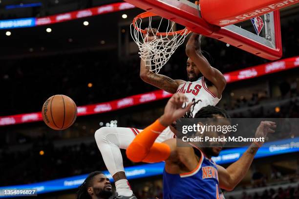 Derrick Jones Jr. #5 of the Chicago Bulls dunks the ball against Derrick Rose of the New York Knicks in the second half at United Center on November...