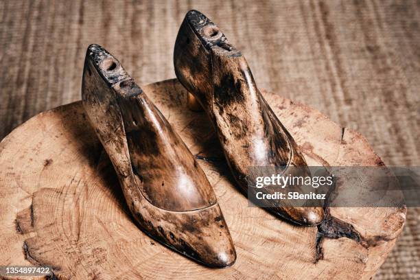 an old shoe last on a tree trunk - shoe repair stock-fotos und bilder