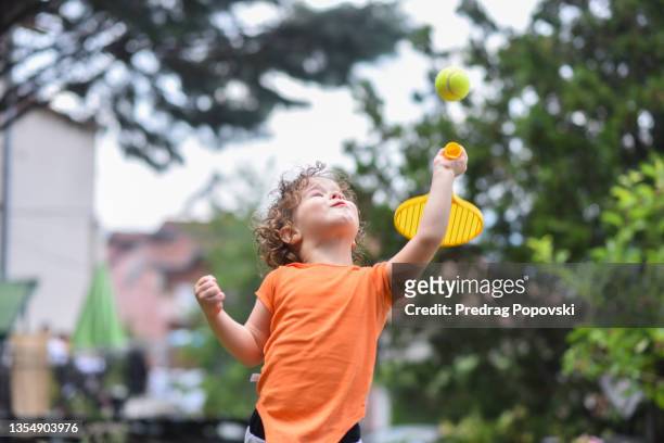 child  playing tennis - tennis boy stock pictures, royalty-free photos & images